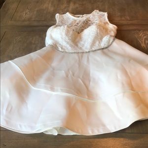 White dress with silver belt around the waist